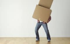 Person holding toppling boxes