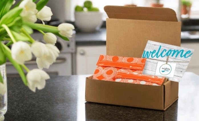 mighty nest welcome card in a cardboard box on a kitchen countertop